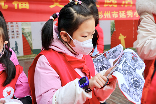 彭州市延秀小学党委进社区开展“志愿服务送关爱 文明实践树新风”写春联、剪纸送祝福活动